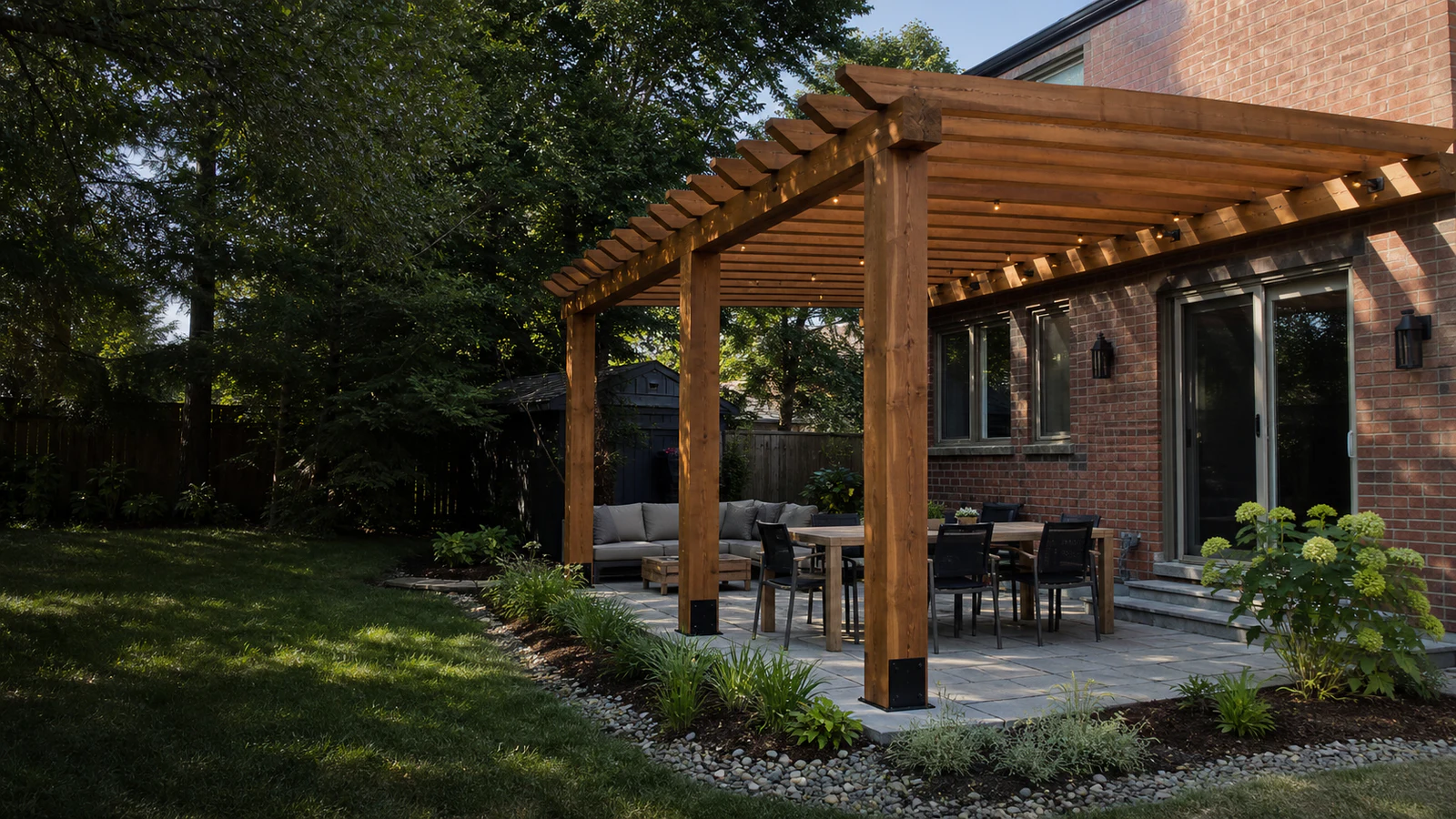 Large timber pergola over a stone patio dining area at a Greater Toronto Area brick home