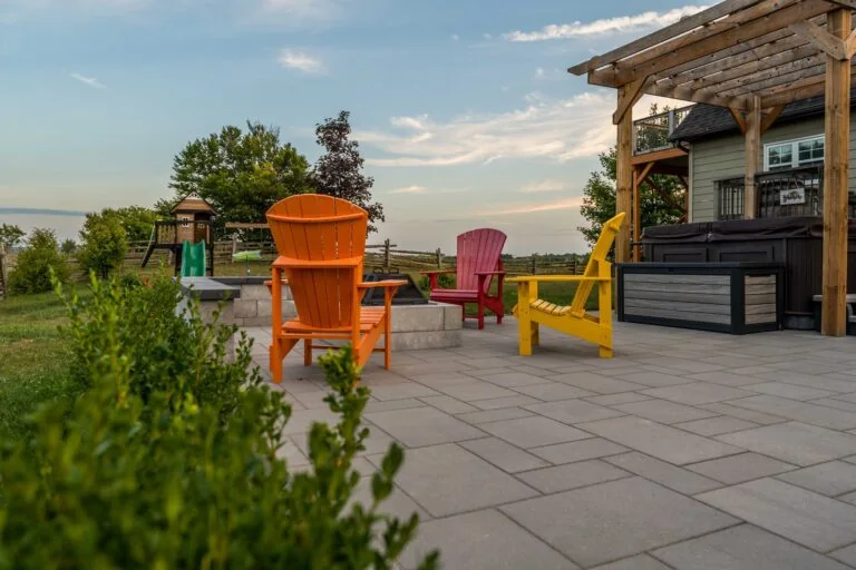 Real Diamond Decks stone patio project with pergola, hot tub and outdoor seating
