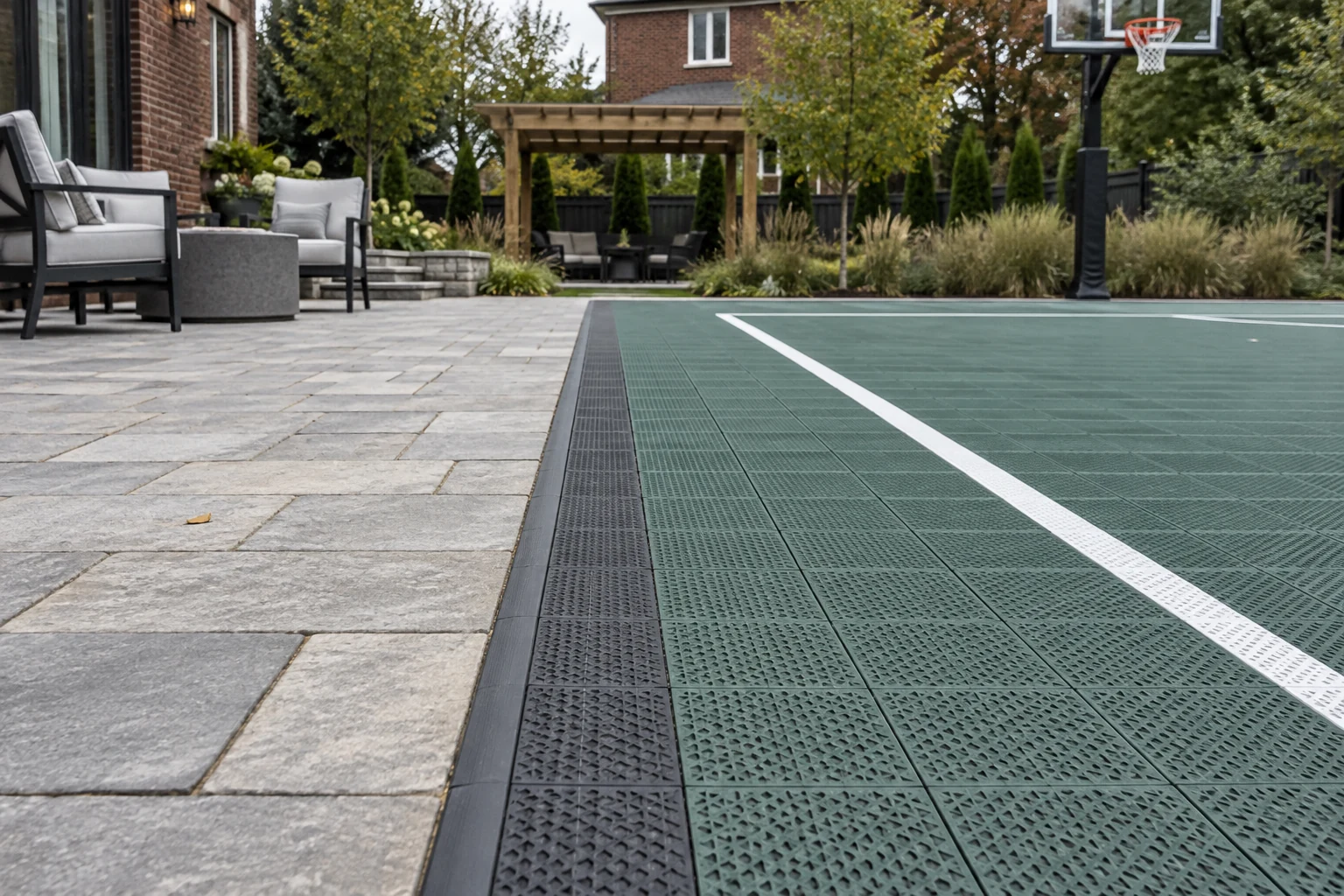 Design concept showing modular sports court tiles meeting a stone patio with a pergola beyond